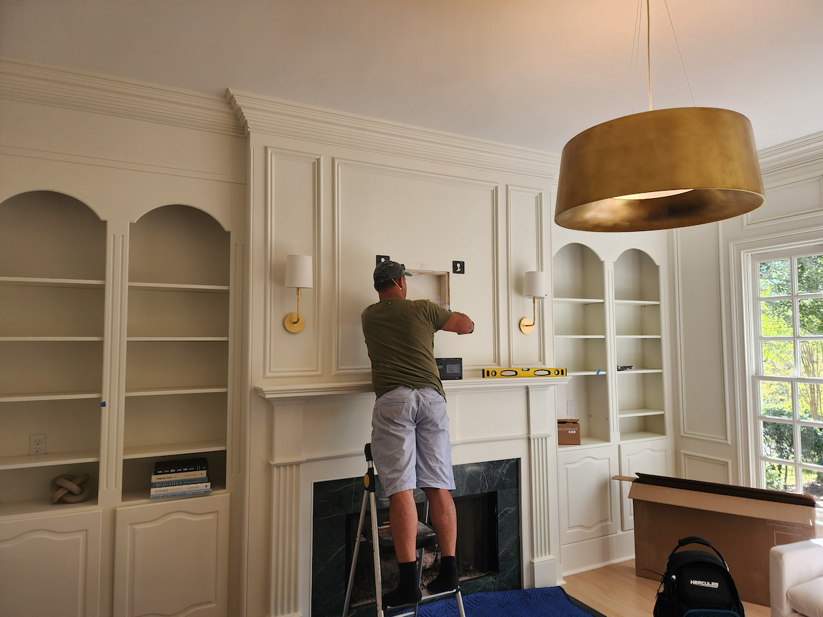 Samsung frame tv mounted above fireplace ballantyne nc — one connect box hidden in wall south charlotte services