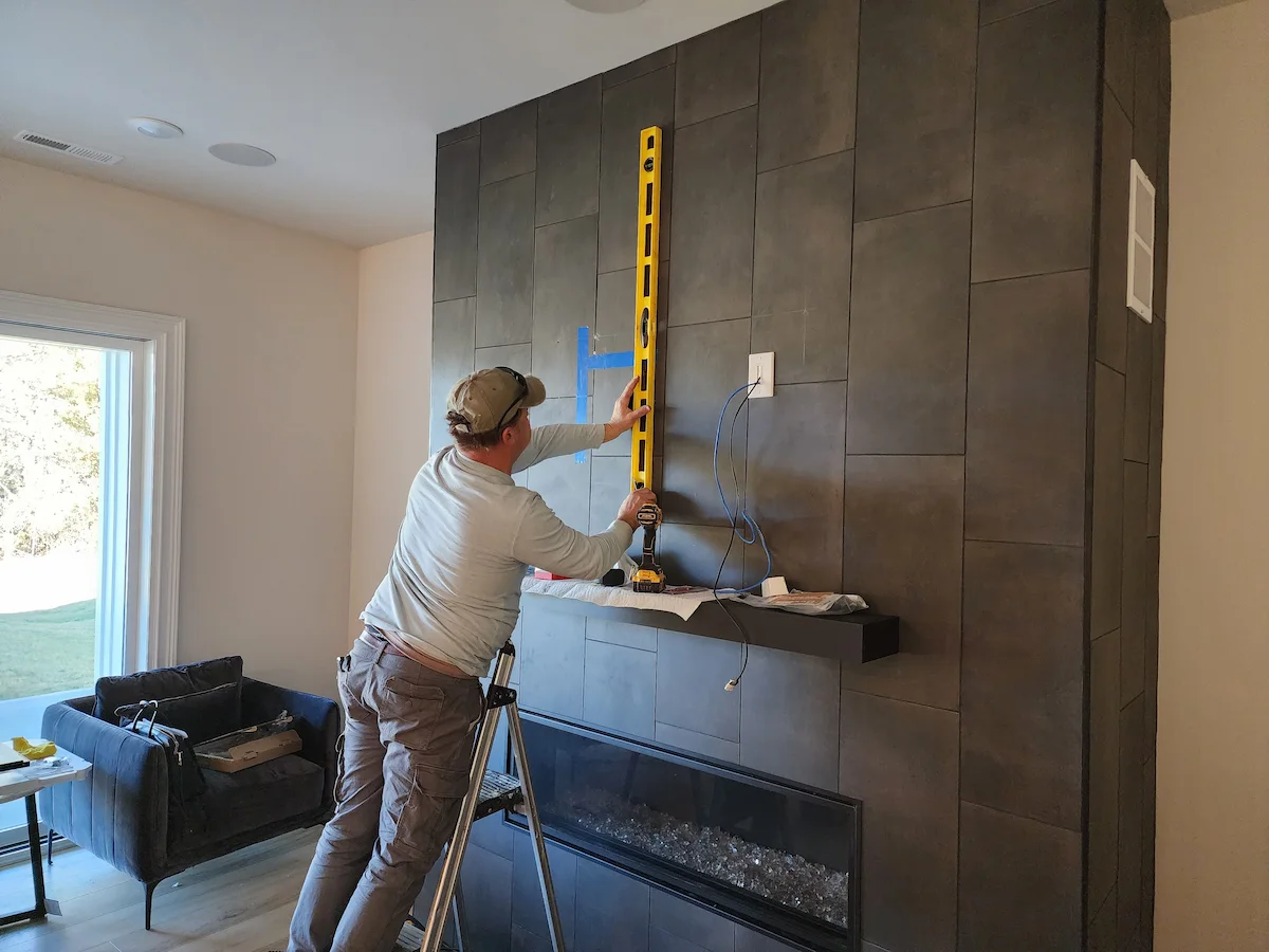 John clay mounting a tv on a tile fireplace surround in seven eagles charlotte nc by south charlotte services