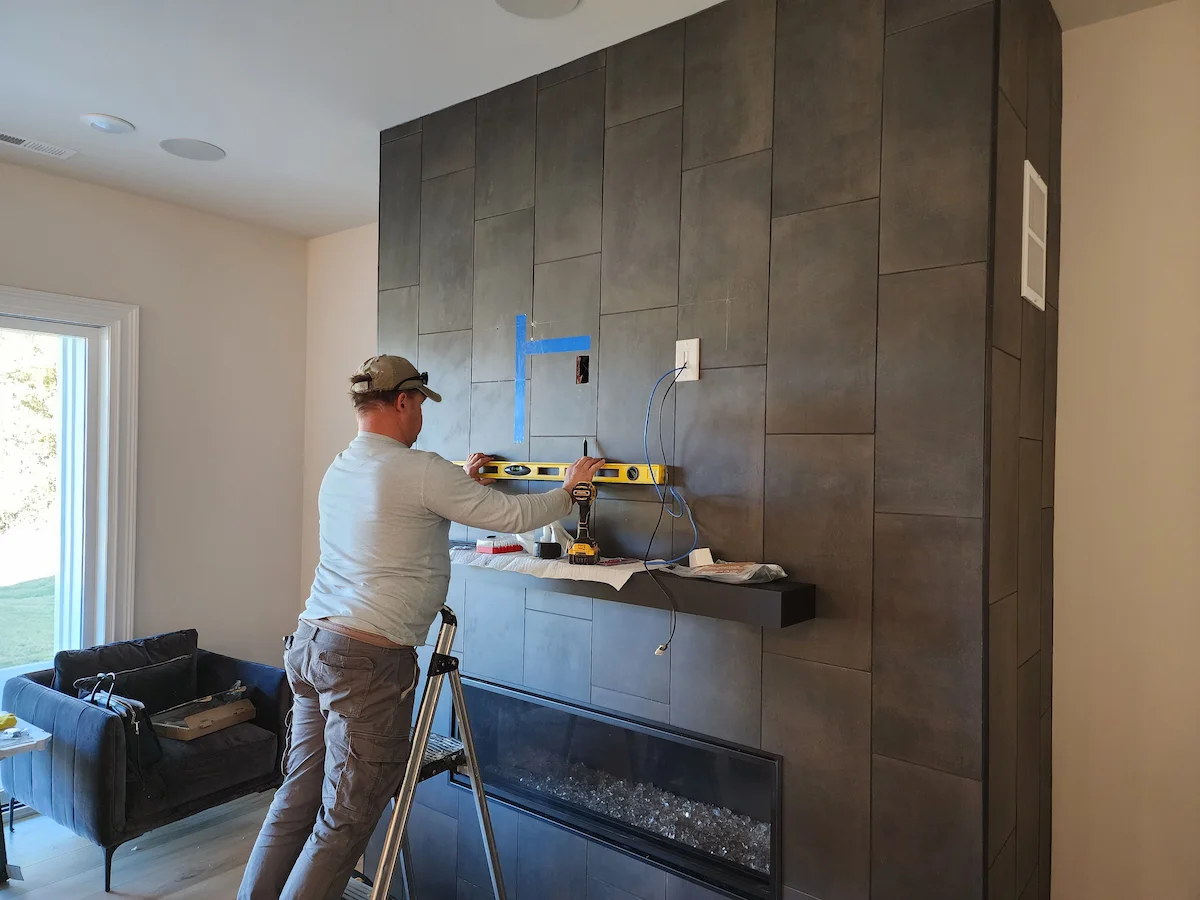 John clay completing a tv mount on a tiled feature wall in seven eagles charlotte nc by south charlotte services