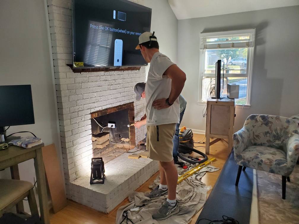 South Charlotte Handyman Services-Installing Electric Fireplace Insert in a existing brick fireplace 11-3-2023 Matthews NC