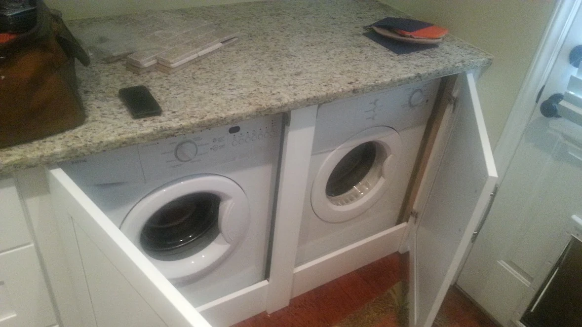 Custom under-counter laundry room carpentry installation in waxhaw nc showing built-in cabinet supports