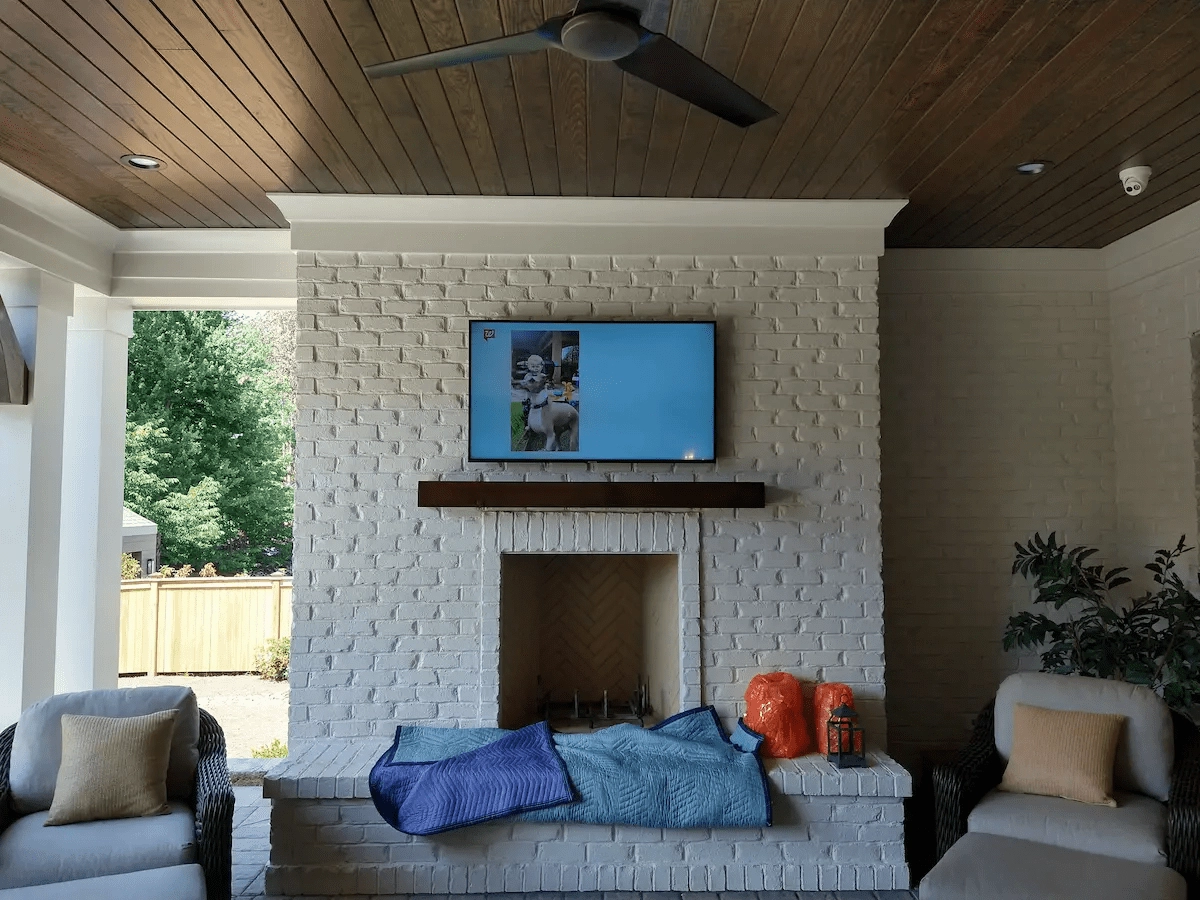 John clay completing an outdoor fireplace tv mounting job in matthews nc with weatherproof bracket by south charlotte services