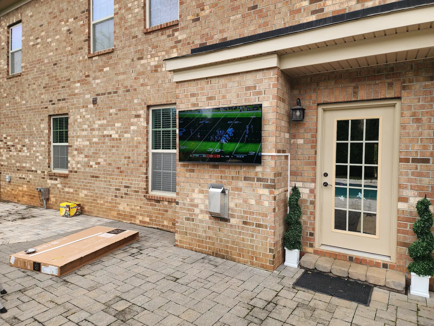 Tv mounting on brick outdoor fireplace charlotte nc by south charlotte services