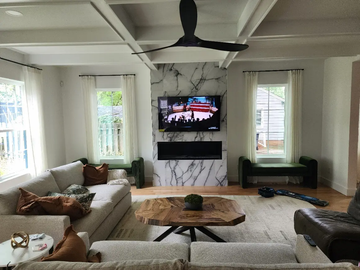 Flawless Samsung Frame TV mounted on a marble fireplace with concealed wires in South Charlotte.